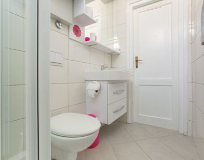 Bathroom with shower, toilet and sink.